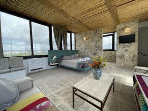 a bedroom with a bed and a couch and a table at Il Dammuso di Noto - Villa con Piscina privata in Avola