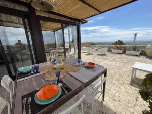 a table with plates on it on a patio at Il Dammuso di Noto - Villa con Piscina privata in Avola