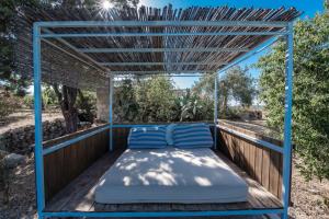 a bed on the back porch of a house at Il Dammuso di Noto - Villa con Piscina privata in Avola