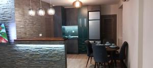 a kitchen with a bar and a table with chairs at Tajna037 in Kruševac