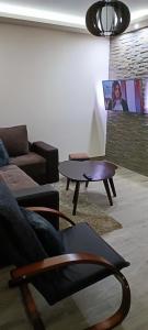 a living room with a couch and a coffee table at Tajna037 in Kruševac