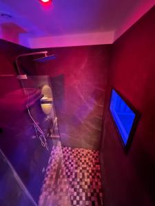 een badkamer met een toilet en een blauw licht bij Suite & Jacuzzi in Givors
