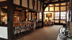 a large room with a bar and chairs in a building at Wetterburg am Twistesee in Bad Arolsen