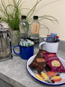 a plate of food sitting on a counter with snacks at The Bridge at Riverside Suites in Bridgnorth