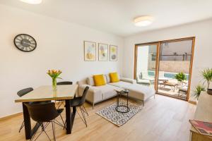a living room with a couch and a table at Vila Rušinac - private heated pool in Kaštela