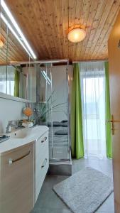 W łazience znajduje się umywalka i lustro. w obiekcie Ferienparadies Gutounik w mieście Pörtschach am Wörthersee
