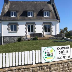 a white house with a sign in front of it at Chez Tib in Trégunc