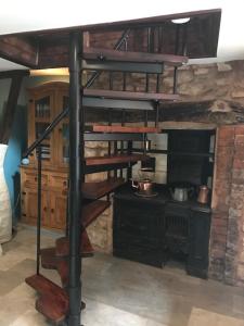 a room with a spiral staircase in a room at Dunster Luxe Nook in Dunster