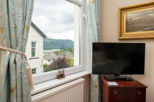 a window with a flat screen tv in a room at The Mount B&B in Keswick
