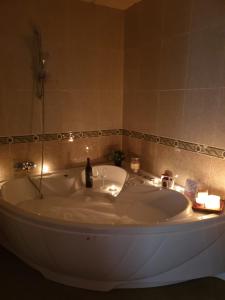 a bath tub in a bathroom with a sink at Casa Maria in Olivenza