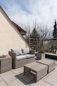 a patio with a couch and tables on a roof at Villa Balladyna in Gdynia