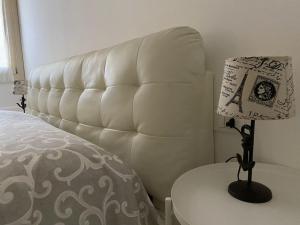 a bedroom with a bed and a table with a lamp at Ca' Contadin in Chioggia