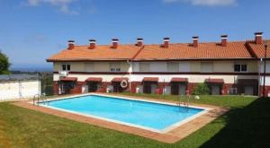 a house with a swimming pool in front of it at Casa La Hayuela Molleda in Ayuela