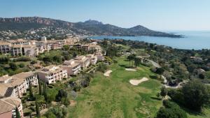 an aerial view of a resort with a golf course at Cap Estérel Rivièra Studio in Saint-Raphaël