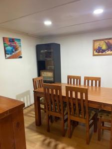 a dining room with a wooden table and chairs at Manso de Velasco in Rancagua