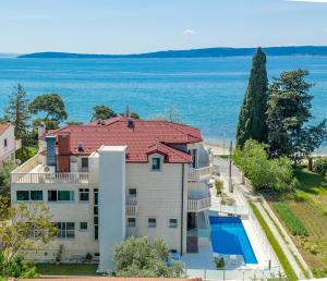an aerial view of a house with a swimming pool at Hotel Riva Kaštela with swimming pool in Kaštela