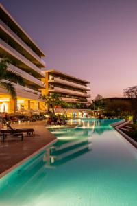 a swimming pool in front of a building at Wyndham Tamarindo in Tamarindo