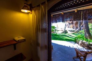 a door to a patio with a view of a yard at Del Wawa in Máncora