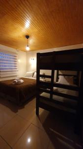 a bedroom with a bed and a wooden ceiling at Hostal Las Heras in Temuco