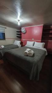 a hotel room with two beds with towels on them at Hostal Las Heras in Temuco