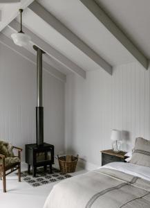 um quarto com uma cama e um fogão a lenha em Maleny Lodge em Maleny
