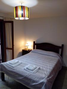 a bedroom with a bed with two towels on it at Los Jazmines in San Salvador de Jujuy