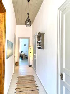 a hallway with white walls and a ceiling at Traditional Stone House in Chandrinos in Khandrinós