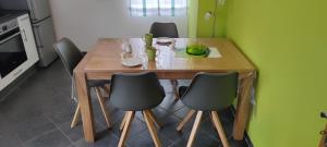 una mesa de madera con 4 sillas alrededor en la cocina en Ferienwohnung Maria Laach, en Glees