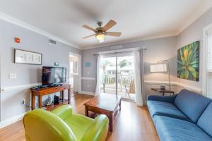 a living room with a blue couch and a tv at Silver Shores in Tybee Island