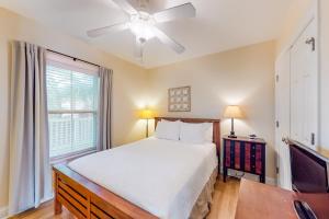 a bedroom with a bed and a tv and a window at Silver Shores in Tybee Island