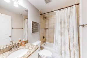 a bathroom with a sink and a toilet and a shower at Silver Shores in Tybee Island +19 photos