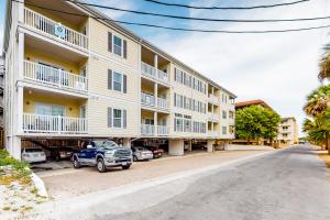 a large apartment building with a truck parked in front of it at Silver Shores in Tybee Island