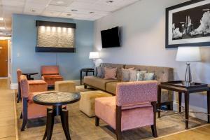 a waiting room with a couch and chairs at Best Western Space Shuttle Inn in Titusville