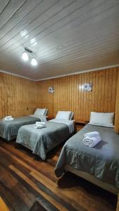 A bed or beds in a room at Hostal Las Heras