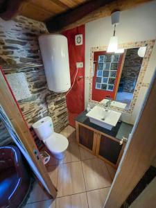 a bathroom with a sink and a toilet and a mirror at Galicia Retreat in Santa Marta de Ortigueira