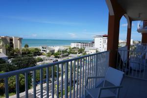 a balcony with a chair and a view of the ocean at Madeira Bay Resort I by Travel Resort Services in St Pete Beach