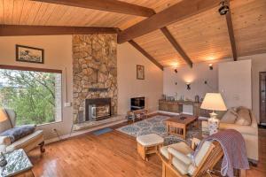 a living room with a large stone fireplace at Quiet Beachfront Family Home with Mt Rainier Views! in Shelton