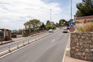 a highway with cars driving down a road with a stone wall at Mont des Olives - Cap D'ail- app4 in Saint-Antoine