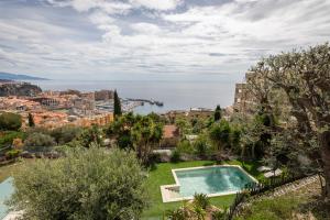 an apartment with a swimming pool and a view of the ocean at Mont des Olives - Cap D'ail- app4 in Saint-Antoine