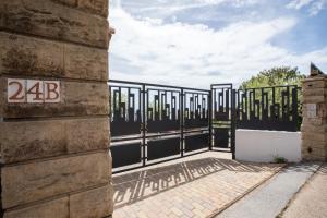 an iron gate on the side of a building at Mont des Olives - Cap D'ail- app4 in Saint-Antoine
