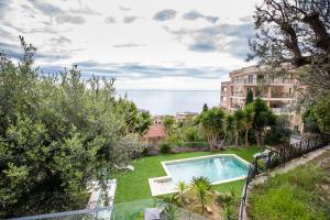 an apartment with a yard with a swimming pool at Mont des Olives - Cap D'ail- app4 in Saint-Antoine
