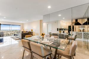 a dining room with a glass table and chairs at I Only Have Eyes for You in Newport Beach