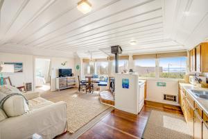 a kitchen and living room with a white ceiling at Seaside Cottage in Bodega Bay