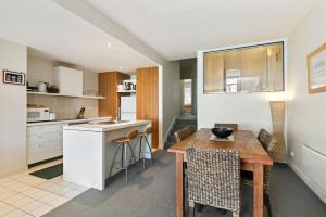 a kitchen and dining room with a wooden table at Apartment 20 Kalimna in Lorne