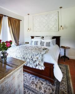 a bedroom with a large bed and a table at Thamarra Cottage in Gleniffer