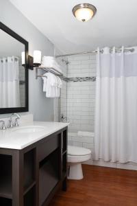 a white bathroom with a sink and a toilet at Club Wyndham Riverside Suites in San Antonio