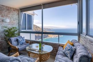 a living room with a view of the ocean at Blue Dream: Panoramic view on heights over the sea in La Matanza de Acentejo