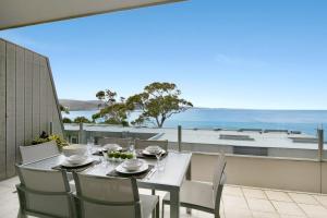 a table and chairs on a balcony with a view of the ocean at Apartment 25 Kalimna in Lorne