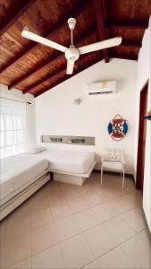 a bedroom with a bed and a ceiling fan at Alquiler casa en la playa, Tolu in Tolú