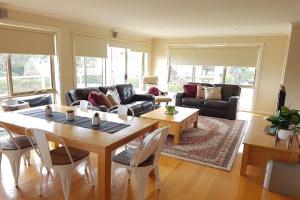 a living room with a table and a couch at The Dunes 1 in Apollo Bay